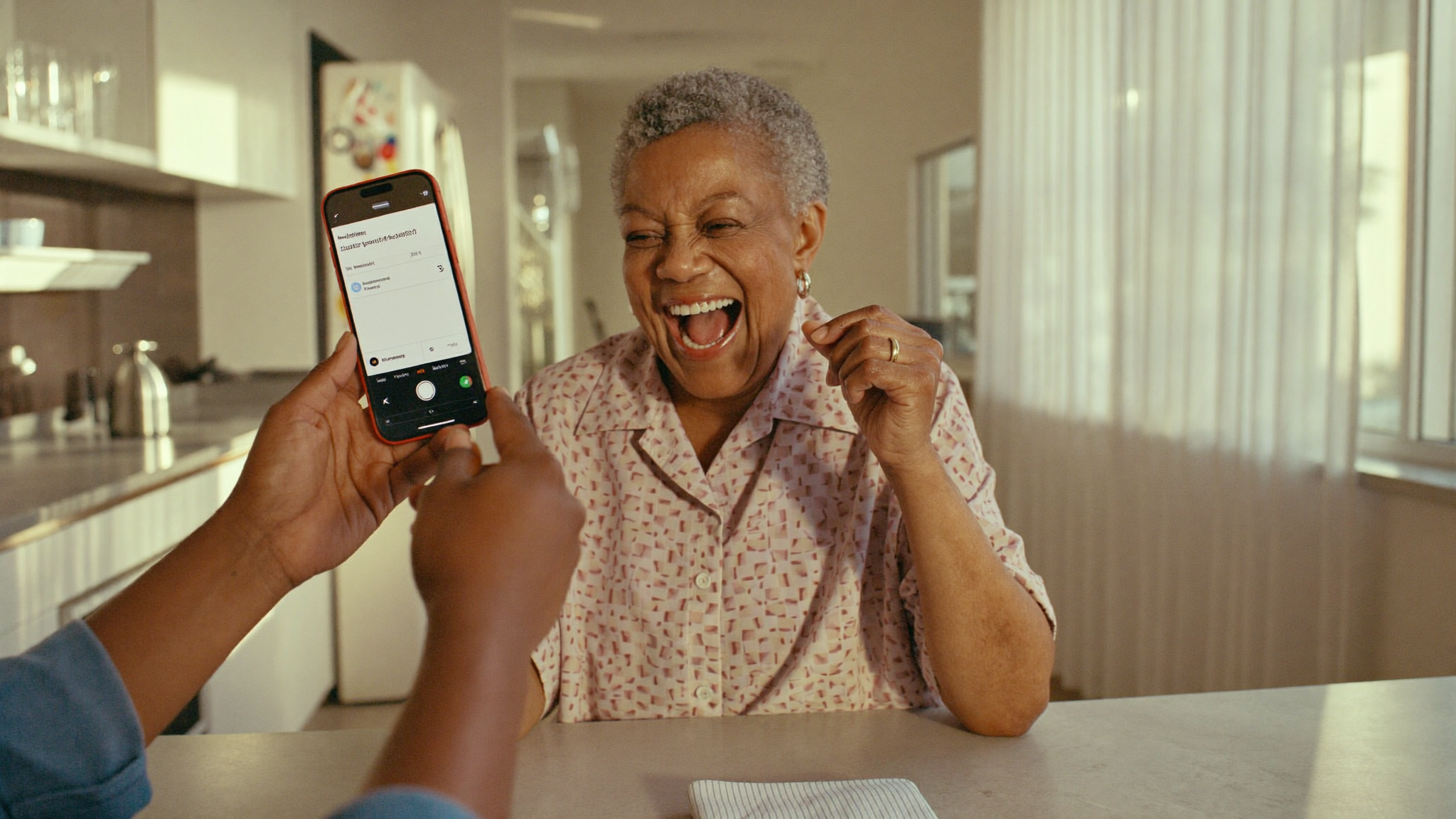 A grandmother in Harare smiling at a payment notification on her phone